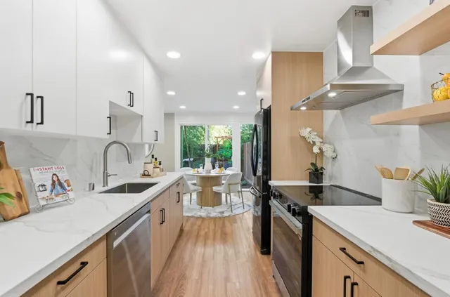 a kitchen with a sink a stove and cabinets