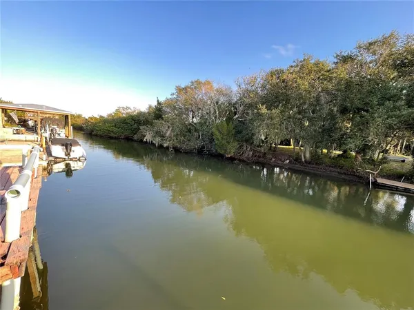 an aerial view of residential houses with outdoor space and lake view