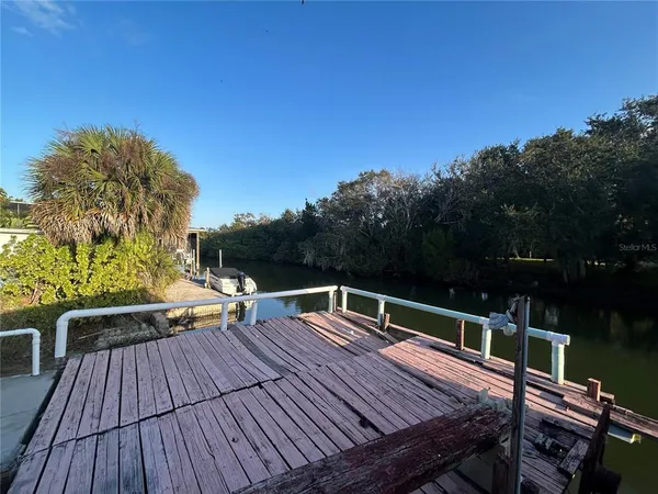 a view of deck with seating area and trees