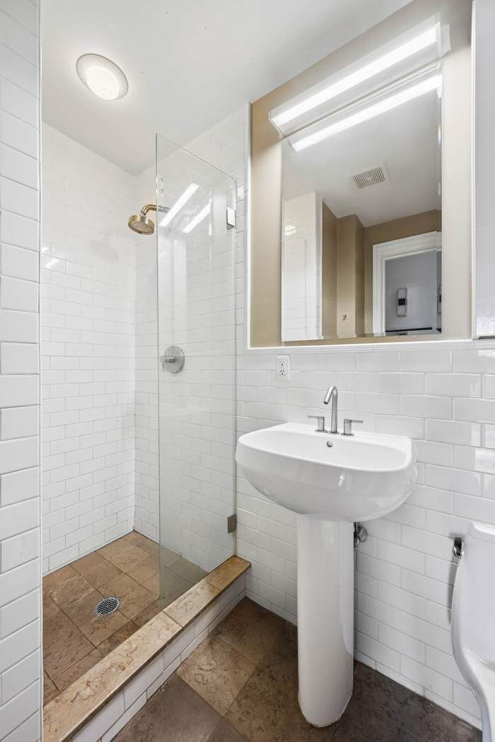 57 Front Street, Unit 604 Brooklyn, NY 11201 - Photo 8 of 14 a bathroom with a sink a toilet and shower