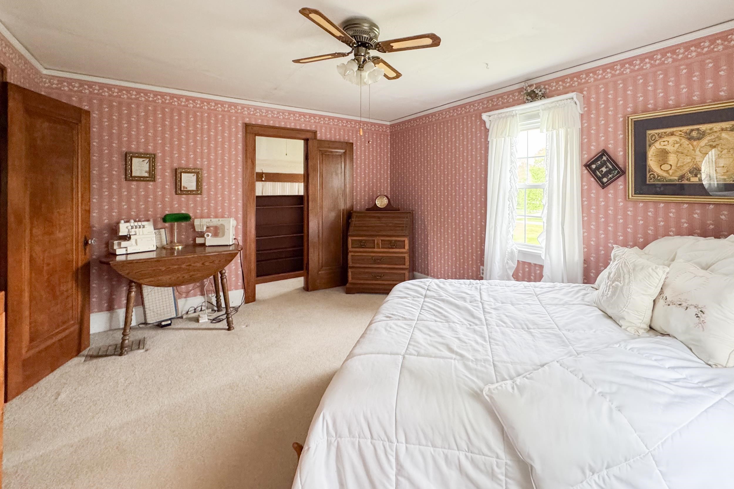 1661 Mill Road Rockford, IL 61108 - Photo 14 of 24 a bedroom with a bed and a chandelier