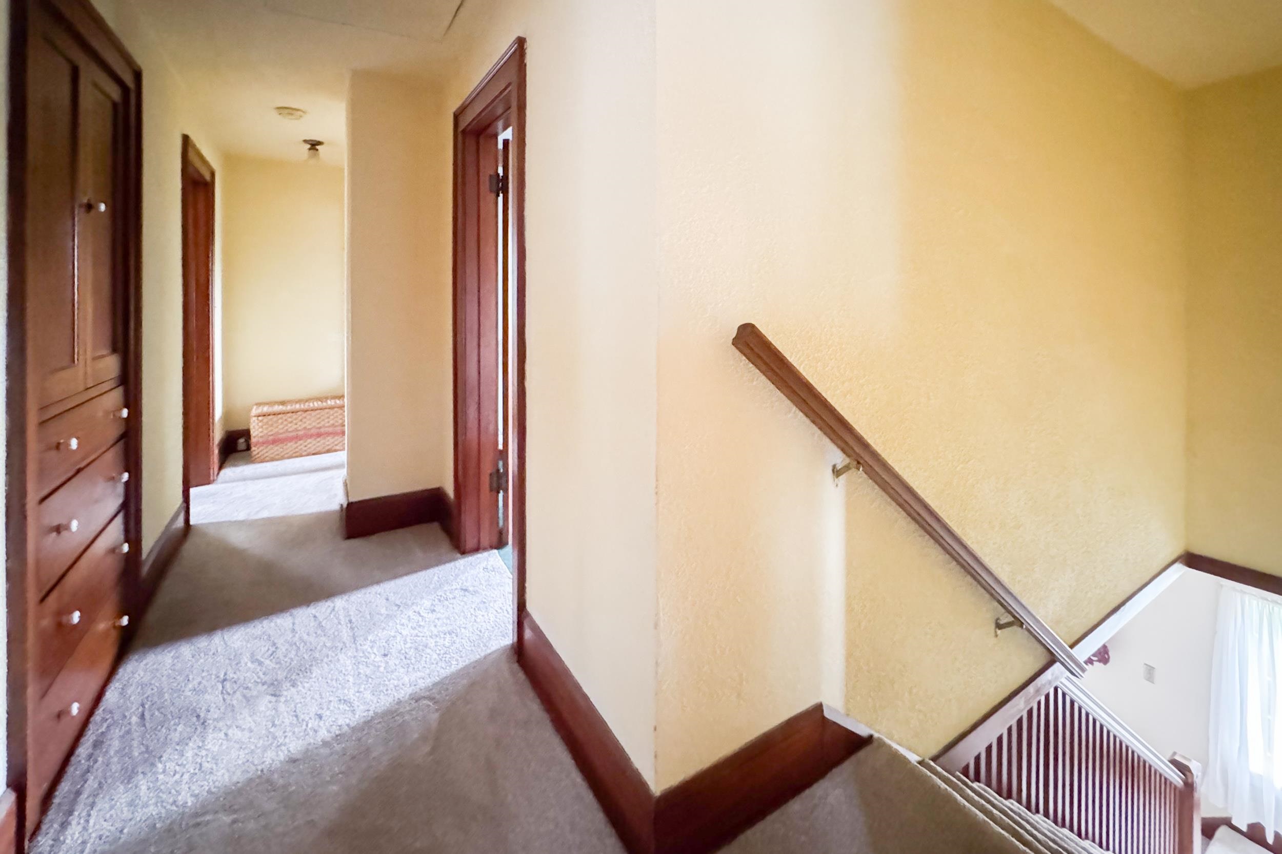 1661 Mill Road Rockford, IL 61108 - Photo 21 of 24 a view of a hallway with wooden floor and staircase