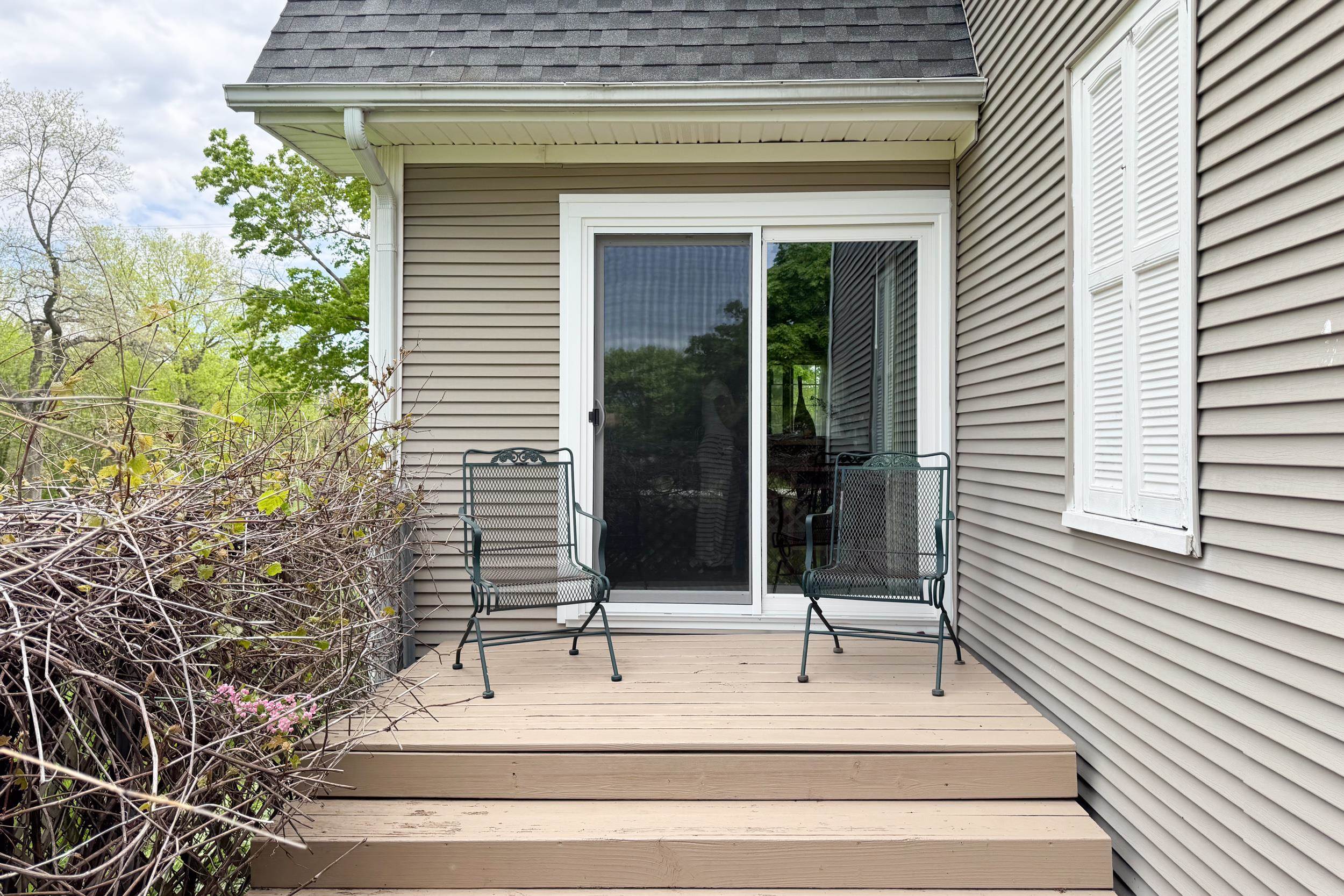 1661 Mill Road Rockford, IL 61108 - Photo 4 of 24 a view of a patio with a table and chairs and potted plants
