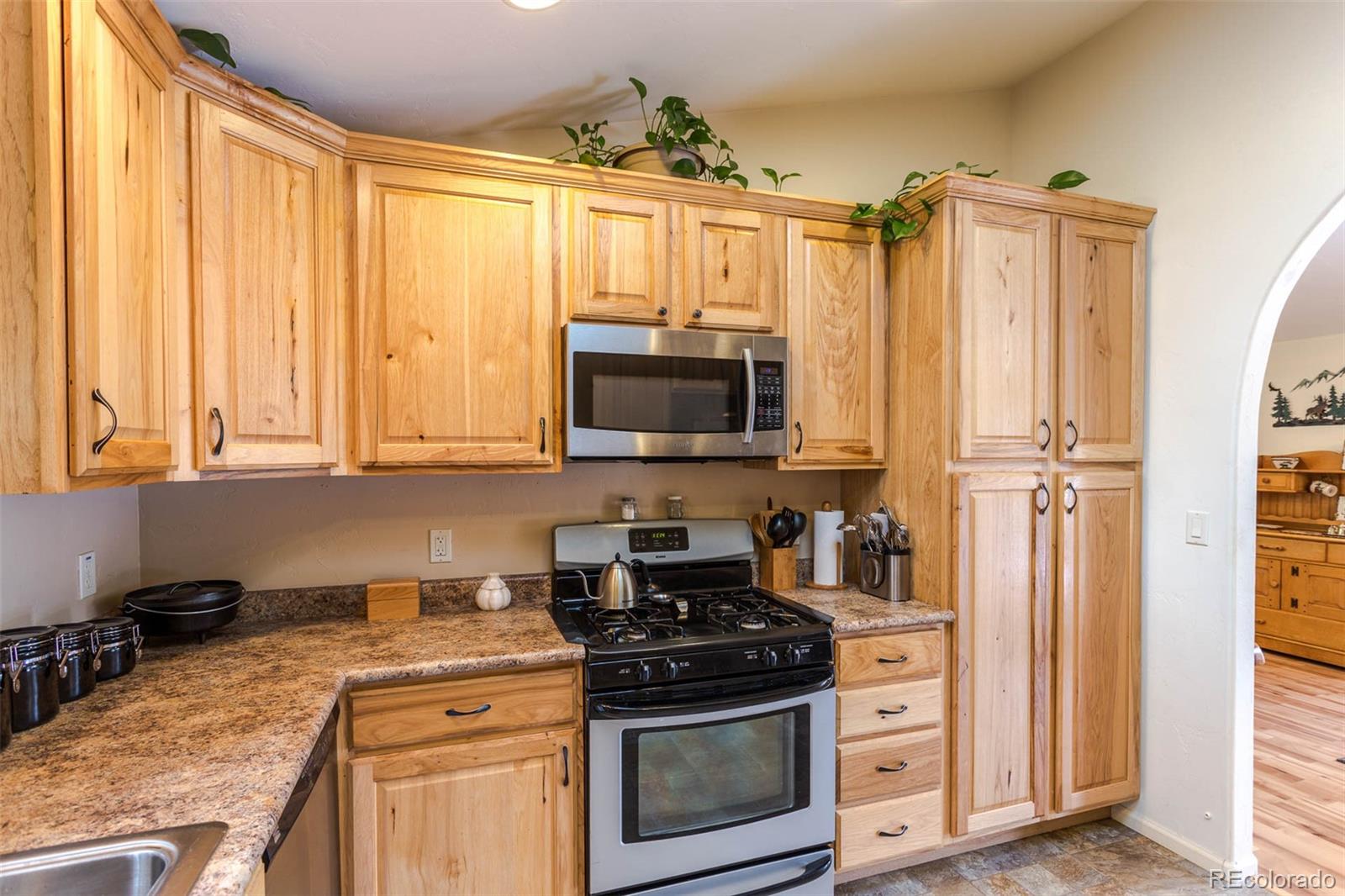 32147 Sylvan Road Golden, CO 80403 - Photo 13 of 27 a kitchen with stainless steel appliances granite countertop a stove a sink and a refrigerator