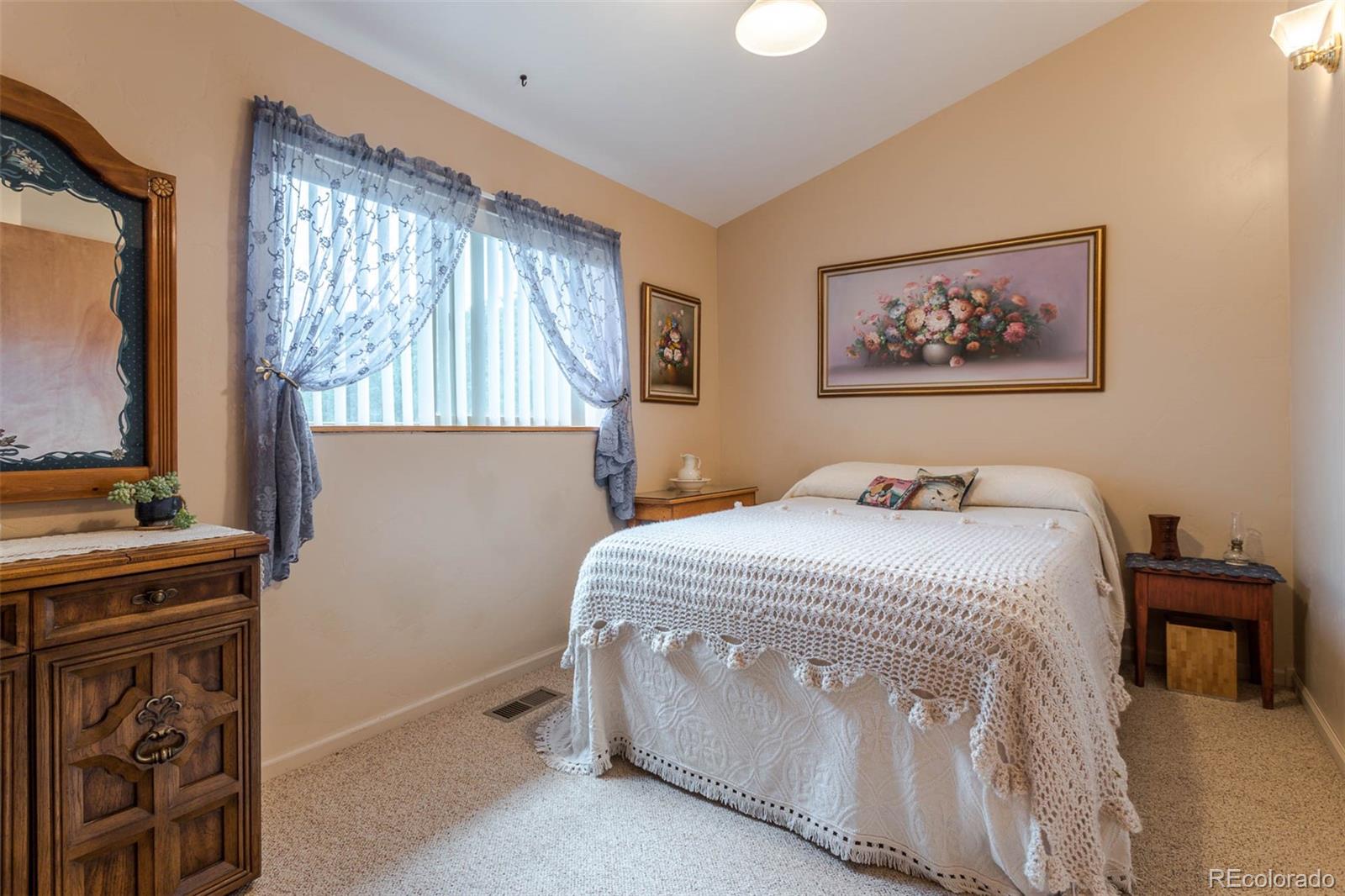 32147 Sylvan Road Golden, CO 80403 - Photo 16 of 27 a bedroom with a bed and a flat screen tv