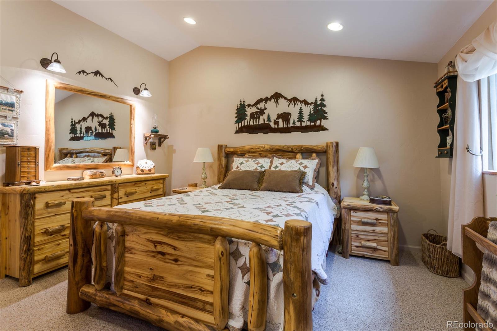 32147 Sylvan Road Golden, CO 80403 - Photo 17 of 27 a bedroom with a bed and a tv in it