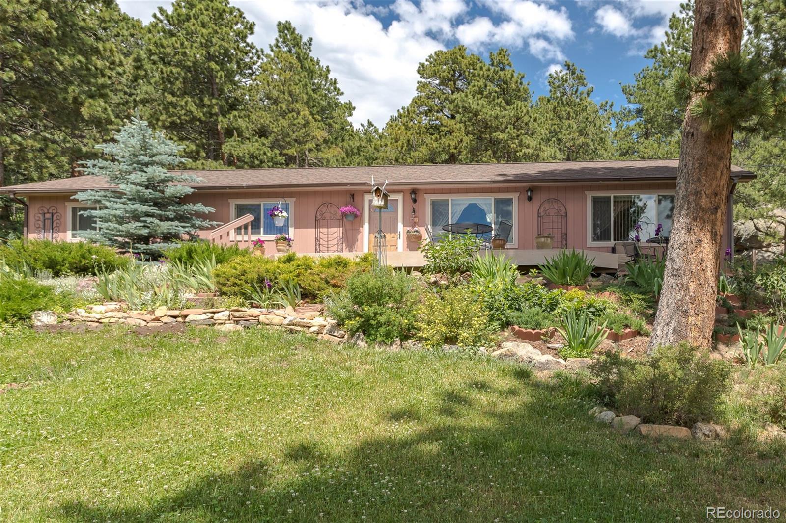 32147 Sylvan Road Golden, CO 80403 - Photo 2 of 27 a house view with a garden space