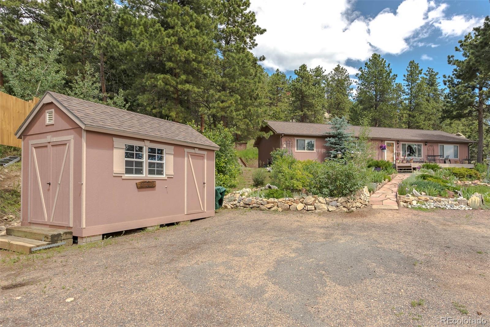 32147 Sylvan Road Golden, CO 80403 - Photo 23 of 27 a view of a house with a garden