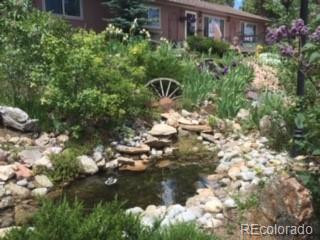 32147 Sylvan Road Golden, CO 80403 - Photo 24 of 27 a view of a back yard of the house and green space