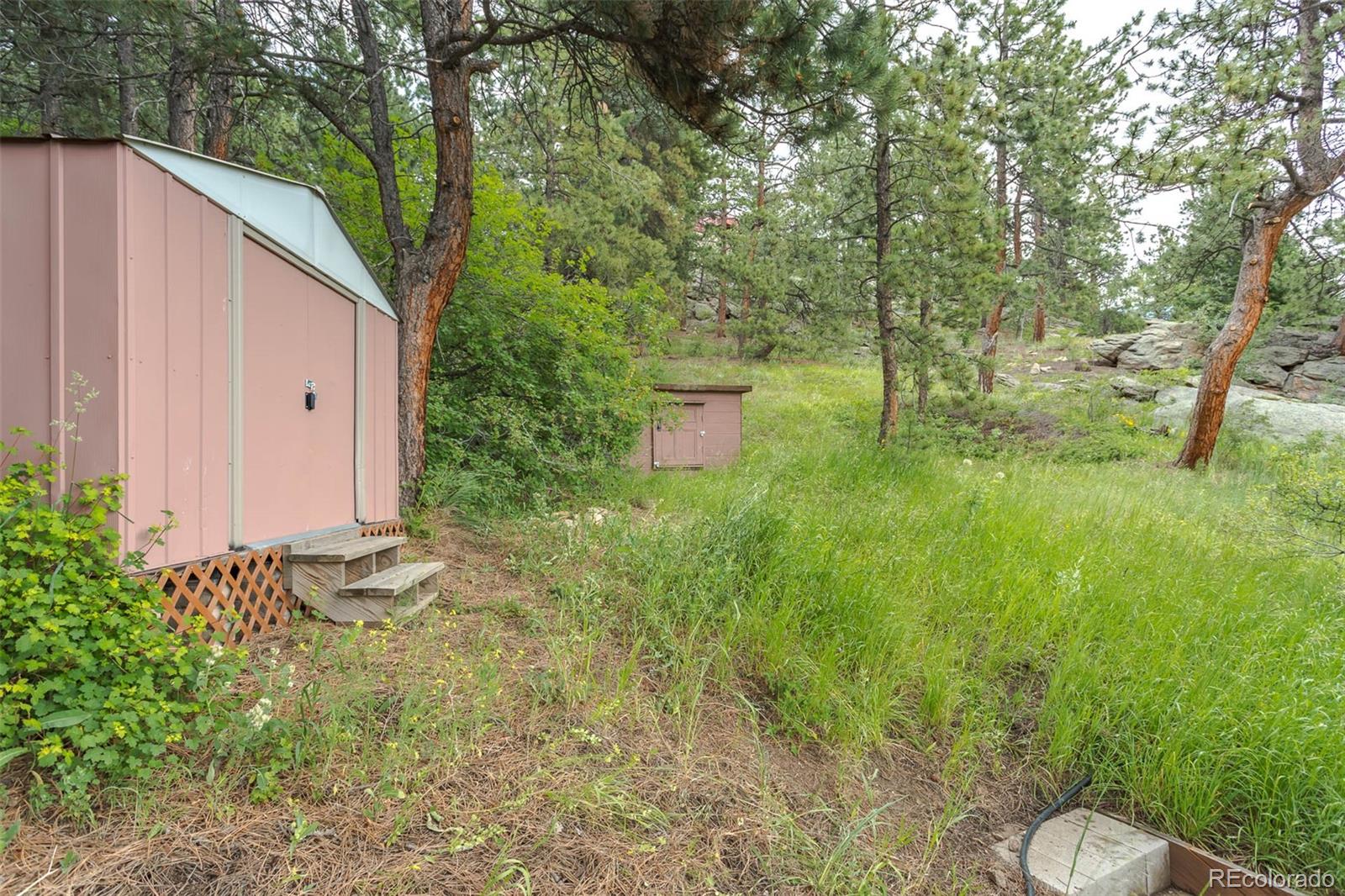32147 Sylvan Road Golden, CO 80403 - Photo 27 of 27 a backyard of a house with lots of green space