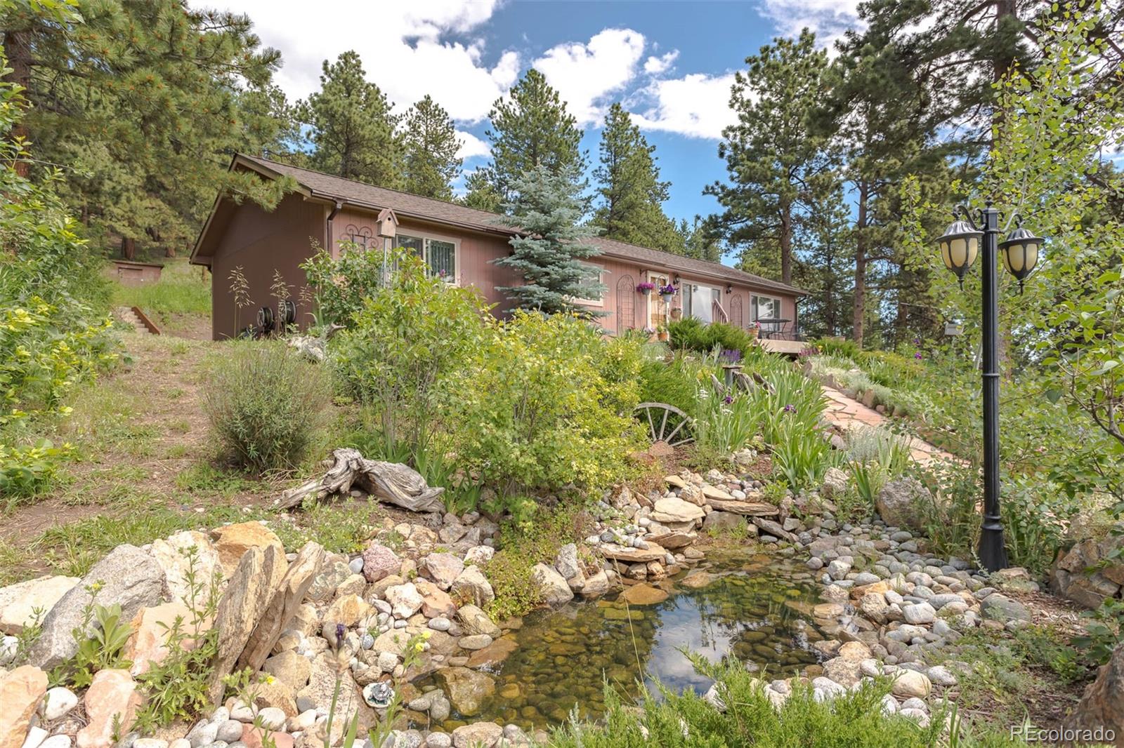 32147 Sylvan Road Golden, CO 80403 - Photo 3 of 27 a view of a house with a yard