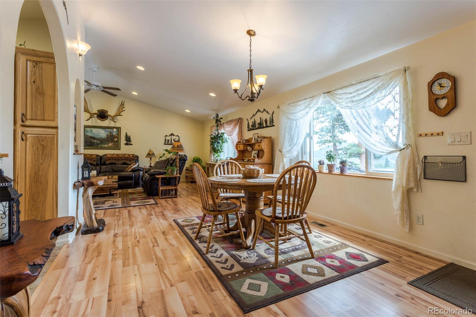32147 Sylvan Road Golden, CO 80403 - Photo 7 of 27 a view of a dining room with furniture window and wooden floor