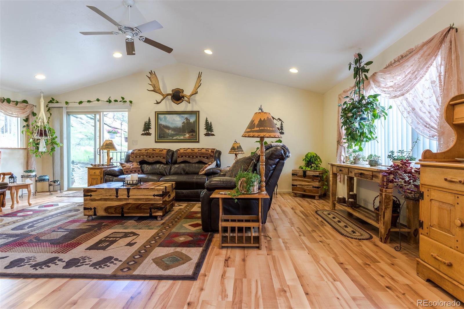 32147 Sylvan Road Golden, CO 80403 - Photo 8 of 27 a living room with furniture and a wooden floor