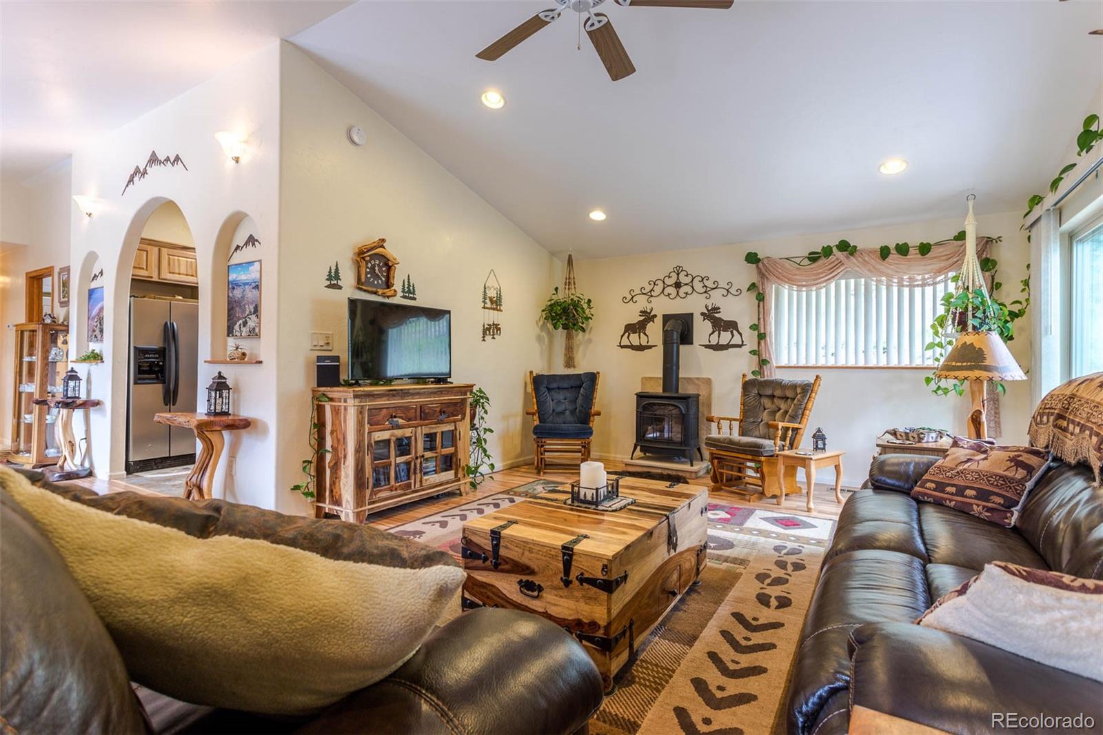 32147 Sylvan Road Golden, CO 80403 - Photo 9 of 27 a living room with furniture and a flat screen tv
