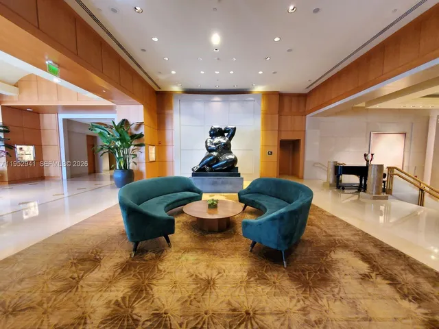 a living room with furniture and a dining table