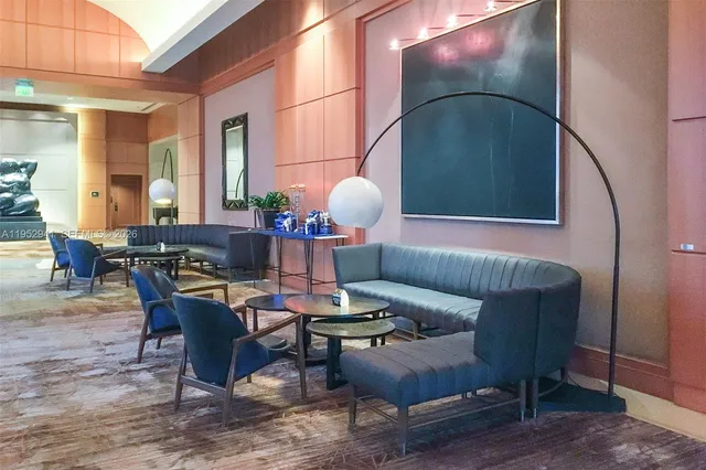 a living room with furniture a lamp and a potted plant