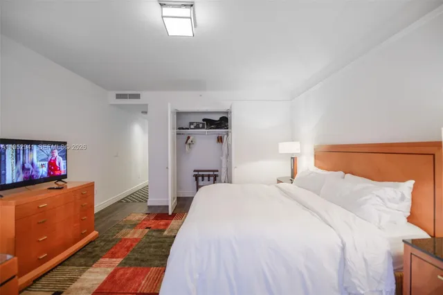 a bedroom with a bed and a dresser in it