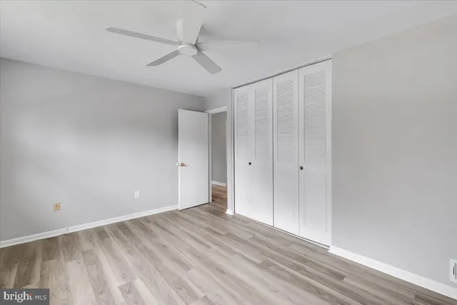 a view of empty room with wooden floor
