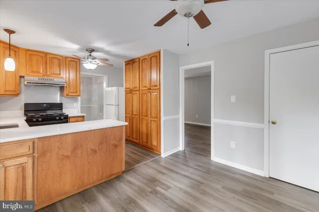 a kitchen with wooden floors and a sink
