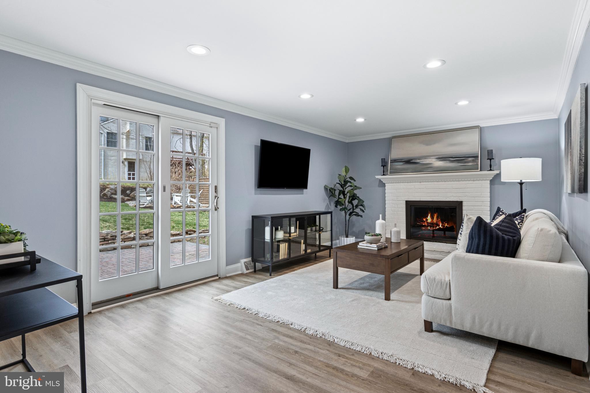 66 Oakford Road Wayne, PA 19087 - Photo 12 of 63 a living room with furniture a fireplace and a flat screen tv