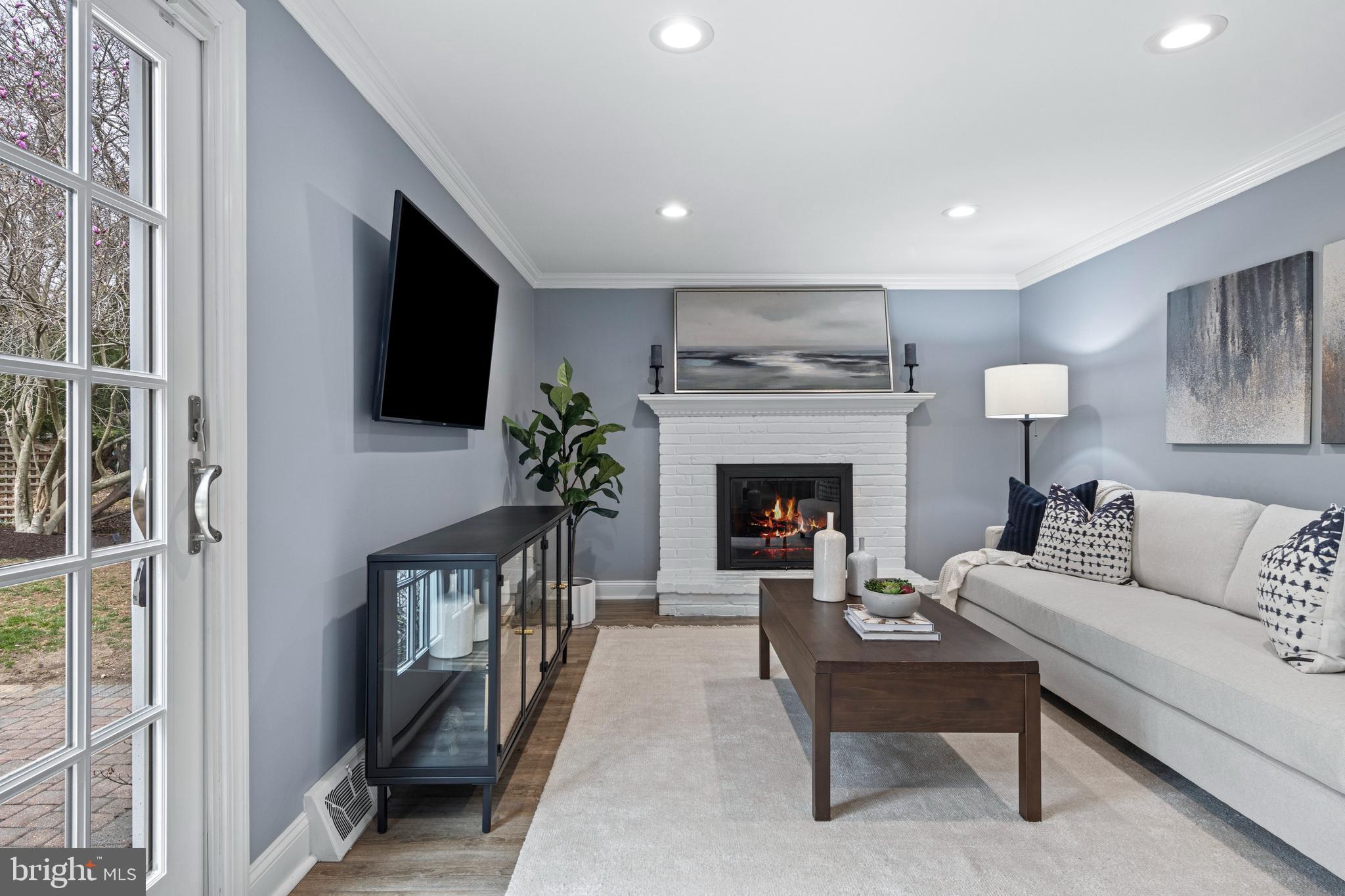 66 Oakford Road Wayne, PA 19087 - Photo 14 of 63 a living room with furniture a flat screen tv and a fireplace