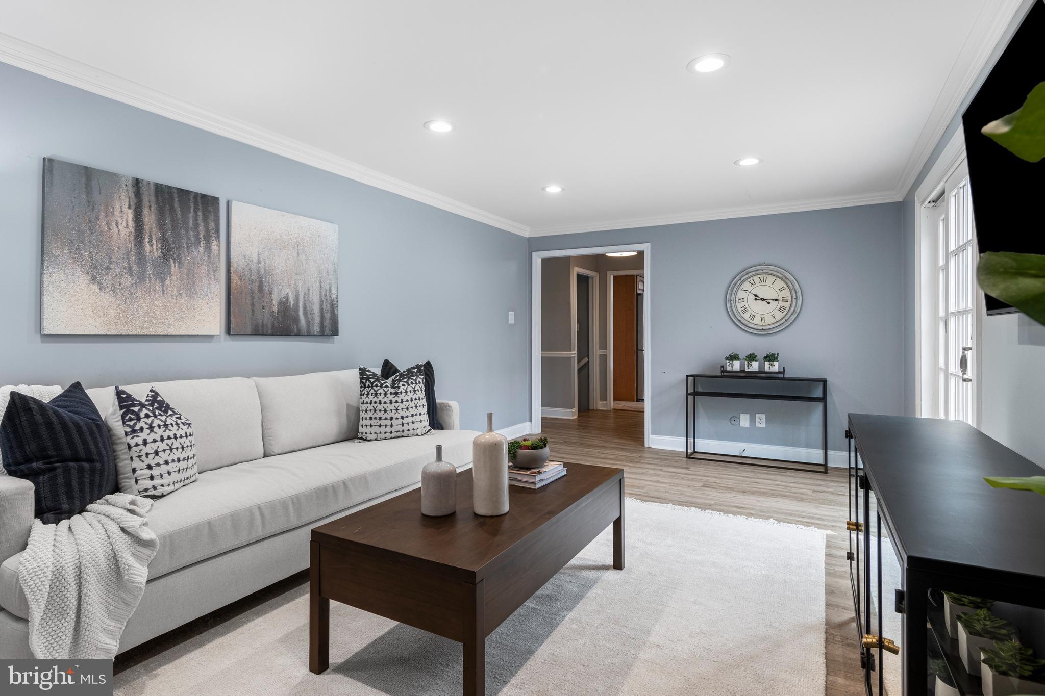 66 Oakford Road Wayne, PA 19087 - Photo 15 of 63 a living room with furniture a flat screen tv and a wall painting