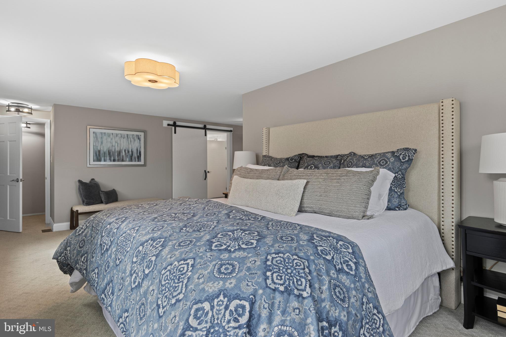 66 Oakford Road Wayne, PA 19087 - Photo 32 of 63 a bedroom with a bed and a chandelier