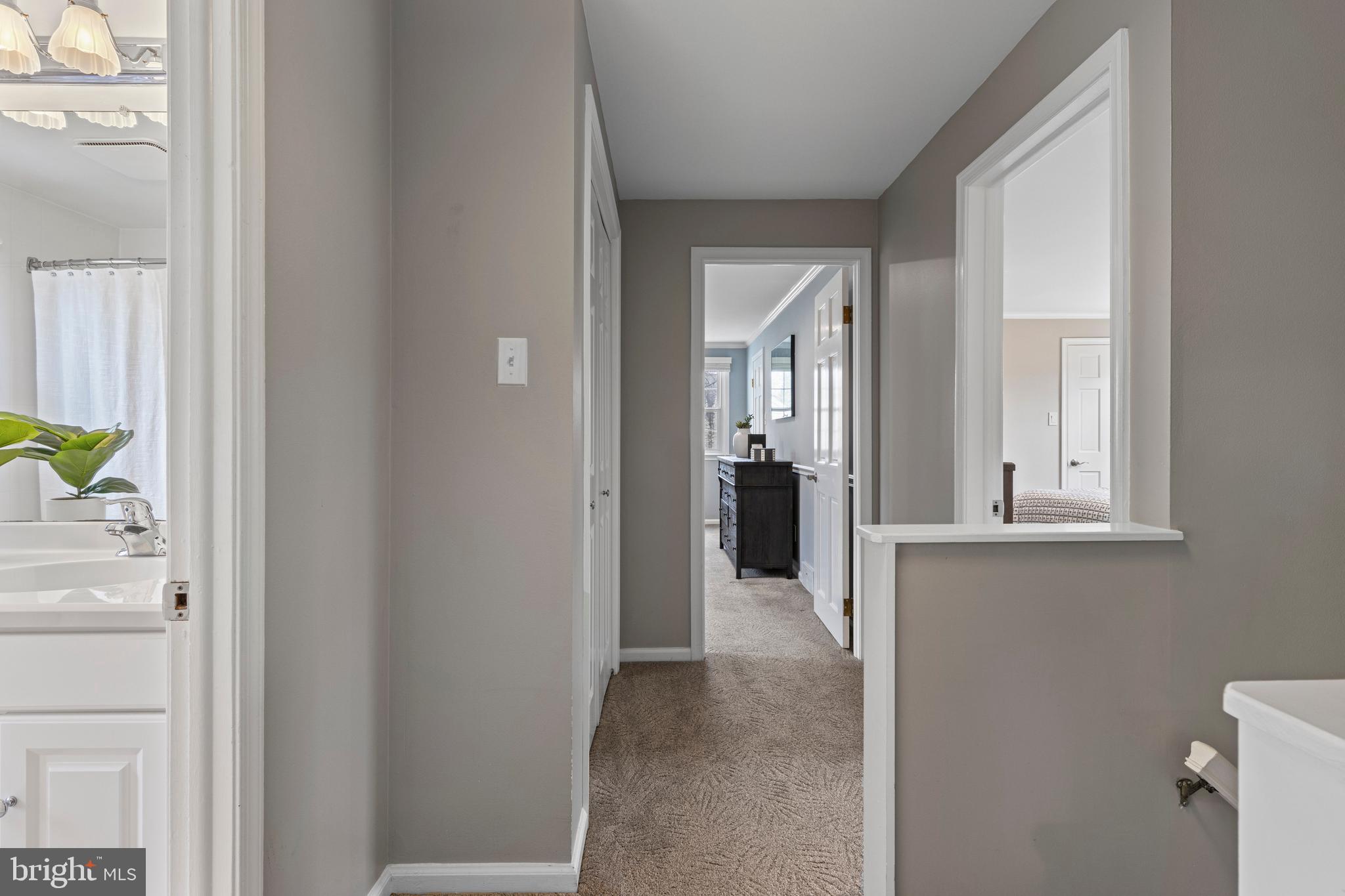 66 Oakford Road Wayne, PA 19087 - Photo 38 of 63 a view of a hallway with wooden floor and a bathroom