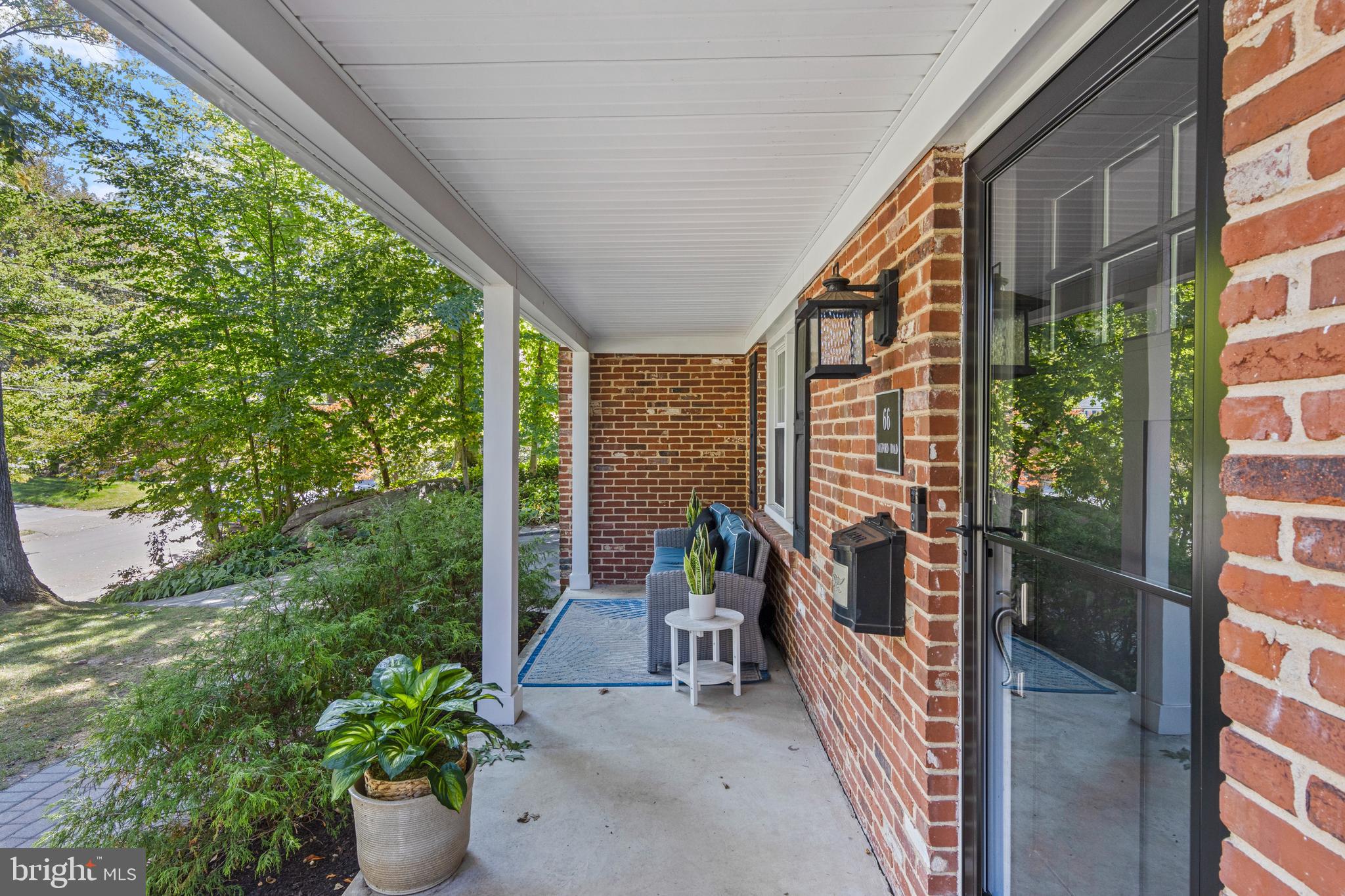 66 Oakford Road Wayne, PA 19087 - Photo 6 of 63 a view of a balcony with chair and potted plants