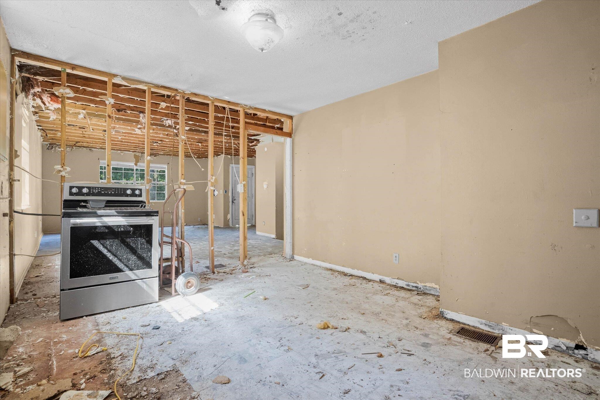 401 Frederick Avenue Fairhope, AL 36532 - Photo 7 of 36 Open concept space featuring exposed wall framing, an existing stainless steel range, and ceiling-mounted lighting