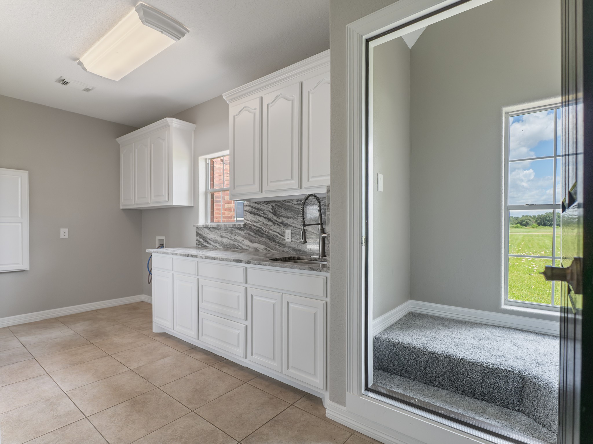 863 Bunkhouse Trail Angleton, TX 77515 - Photo 31 of 42 Granite counters, a deep sink, and a built-in ironing board. A utility room you'll actually enjoy