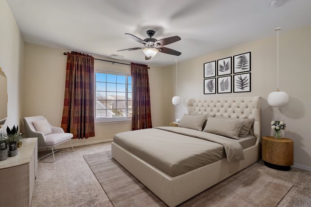 3372 Ravinia Circle Aurora, IL 60504 - Photo 18 of 39 a bedroom with a large bed and a chandelier