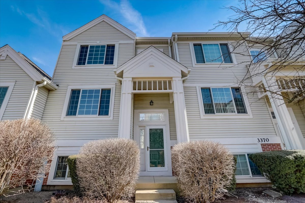 3372 Ravinia Circle Aurora, IL 60504 - Photo 2 of 39 a view of a brick house with large windows