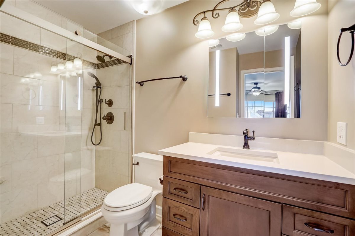 3372 Ravinia Circle Aurora, IL 60504 - Photo 22 of 39 a bathroom with a sink toilet and shower