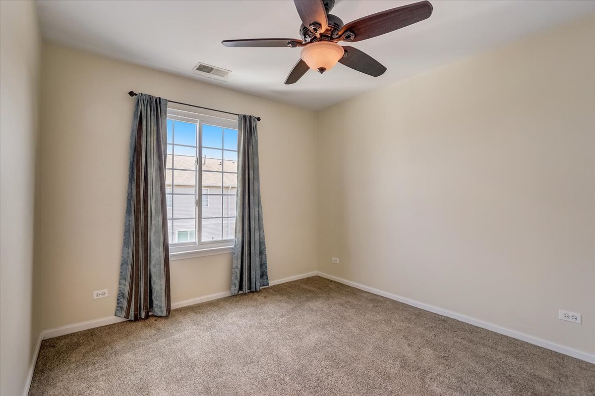 3372 Ravinia Circle Aurora, IL 60504 - Photo 23 of 39 an empty room with windows and fan