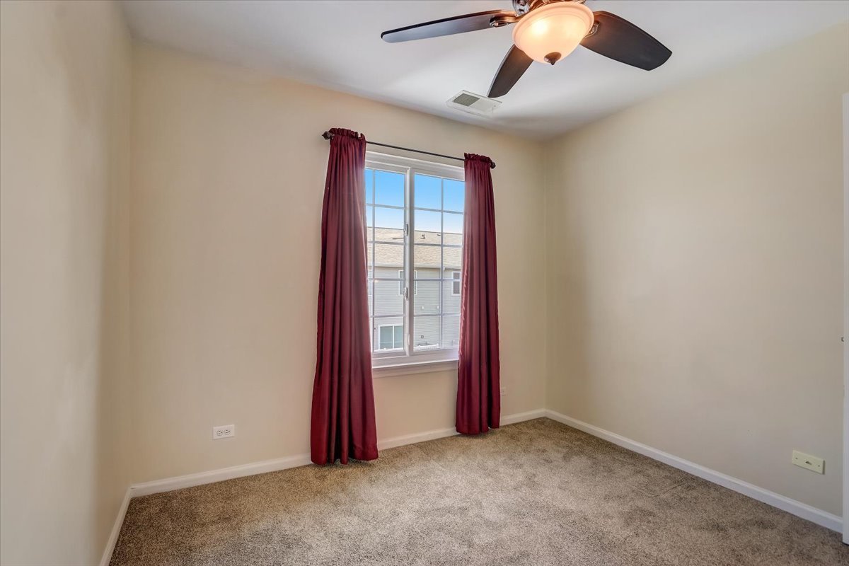 3372 Ravinia Circle Aurora, IL 60504 - Photo 27 of 39 an empty room with windows and fan