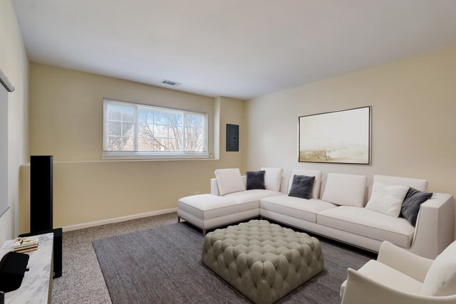 3372 Ravinia Circle Aurora, IL 60504 - Photo 30 of 39 a living room with furniture and a flat screen tv