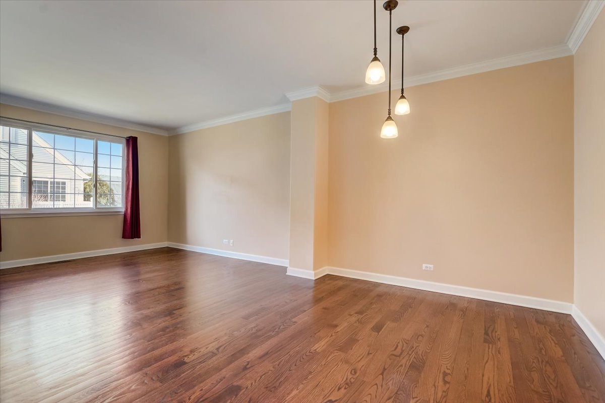 3372 Ravinia Circle Aurora, IL 60504 - Photo 8 of 39 an empty room with wooden floor and windows