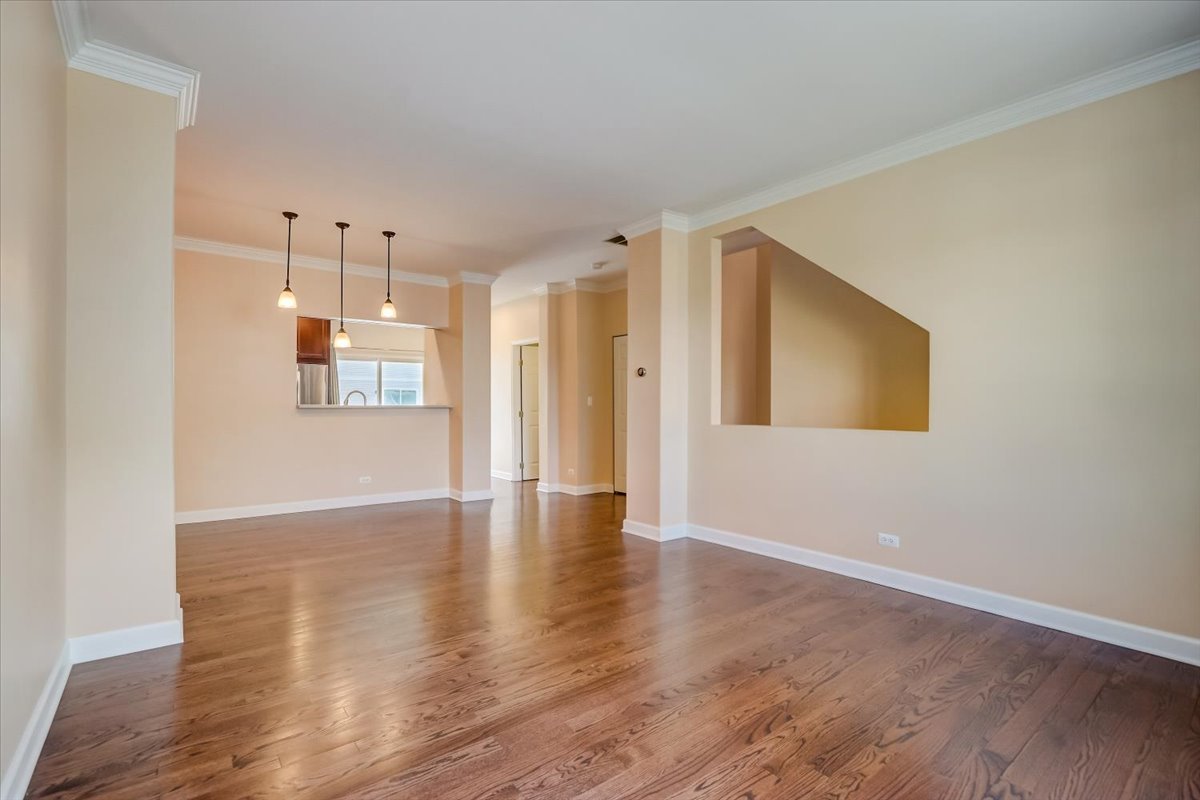 3372 Ravinia Circle Aurora, IL 60504 - Photo 10 of 39 a view of an empty room with wooden floor and a window