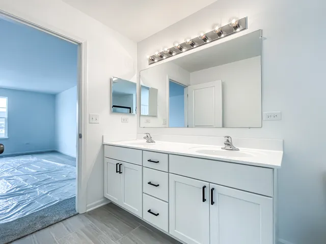 a bathroom with a double vanity sink and mirror