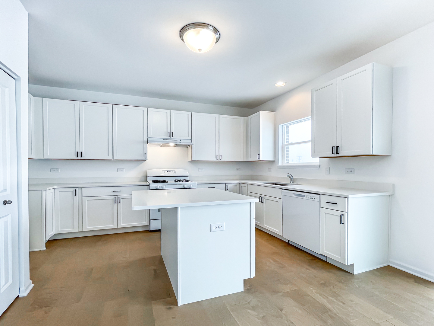895 Willow Road Manteno, IL 60950 - Photo 2 of 14 a kitchen with granite countertop white cabinets and white appliances