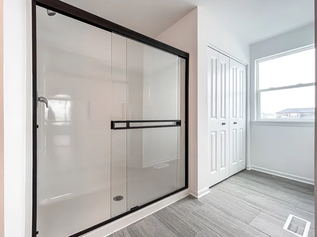 a bathroom with a glass shower door