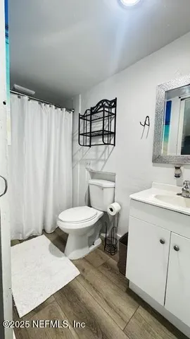 a white toilet sitting next to a bath tub and shower