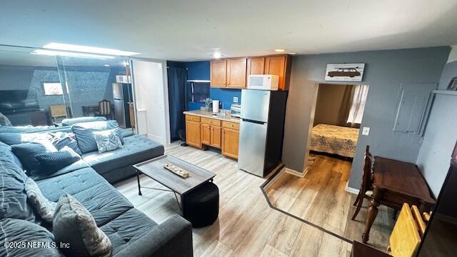 420 9th Avenue South, Unit A Jacksonville Beach, FL 32250 - Photo 6 of 14 a living room with furniture and a dining table with kitchen view