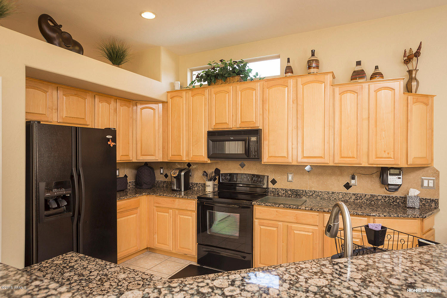 505 East Ranch Road Gilbert, AZ 85296 - Photo 9 of 22 a kitchen with stainless steel appliances granite countertop a refrigerator a stove a sink and a microwave