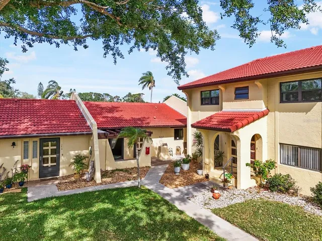a front view of a house with a yard table and chairs