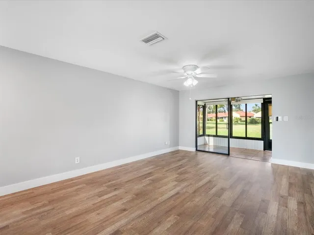 wooden floor in an empty room with a window