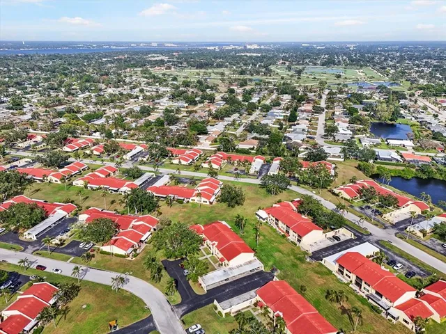 a view of a house with pool and chairs