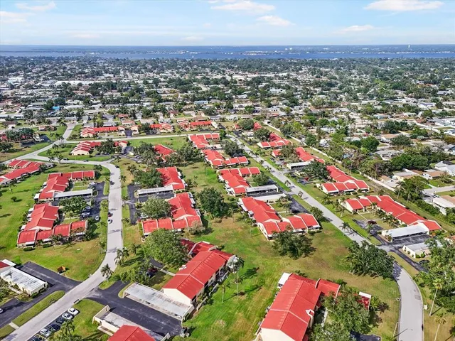 an aerial view of a house with outdoor space and lake view