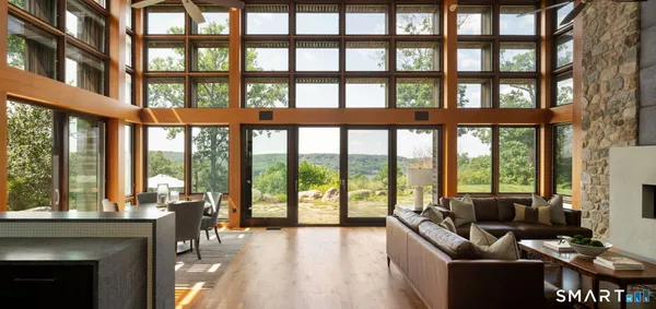a living room filled with furniture and a floor to ceiling windows